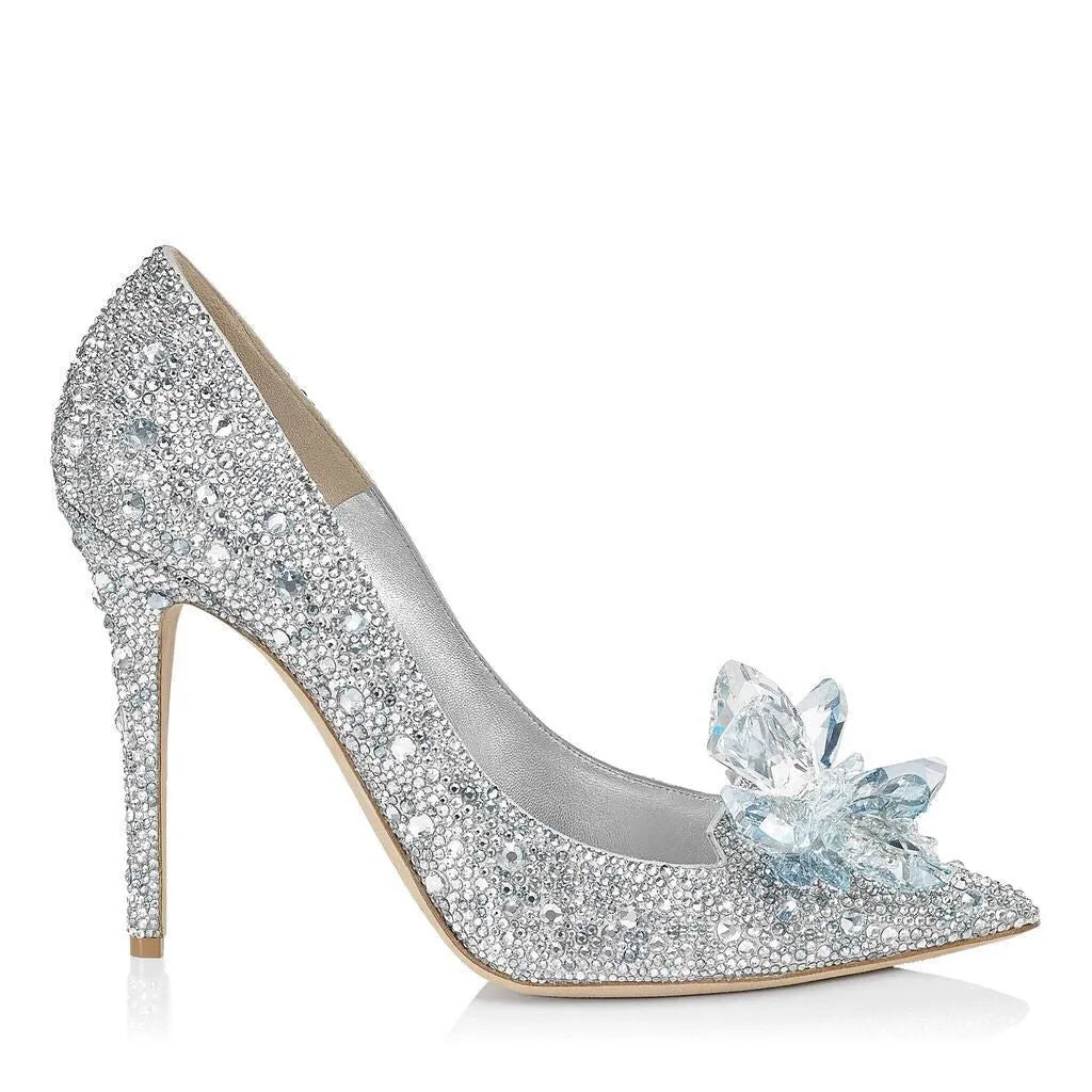 Gold women's pointed toe high heels with rhinestone and sequin decorations on a stiletto heel.