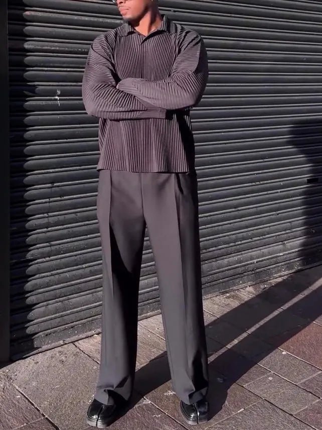 Men's black long-sleeved casual top with pleated detail, made from polyester fabric.