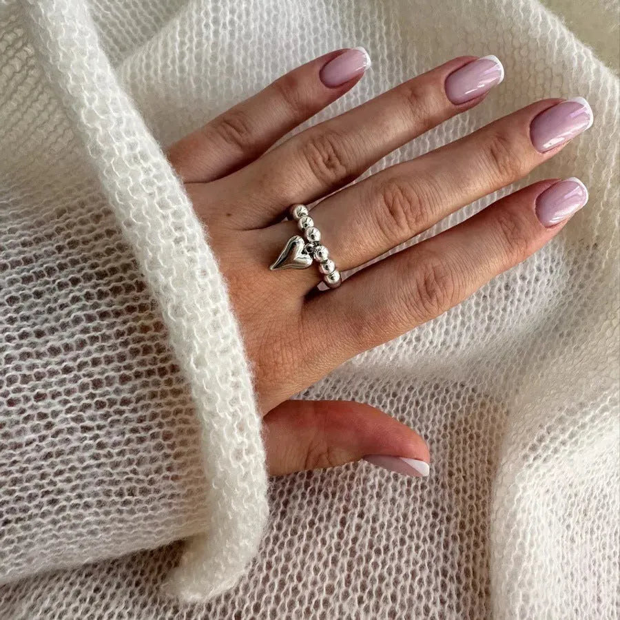 Handmade beaded elastic string love ring with geometric heart design in gold and white colour options