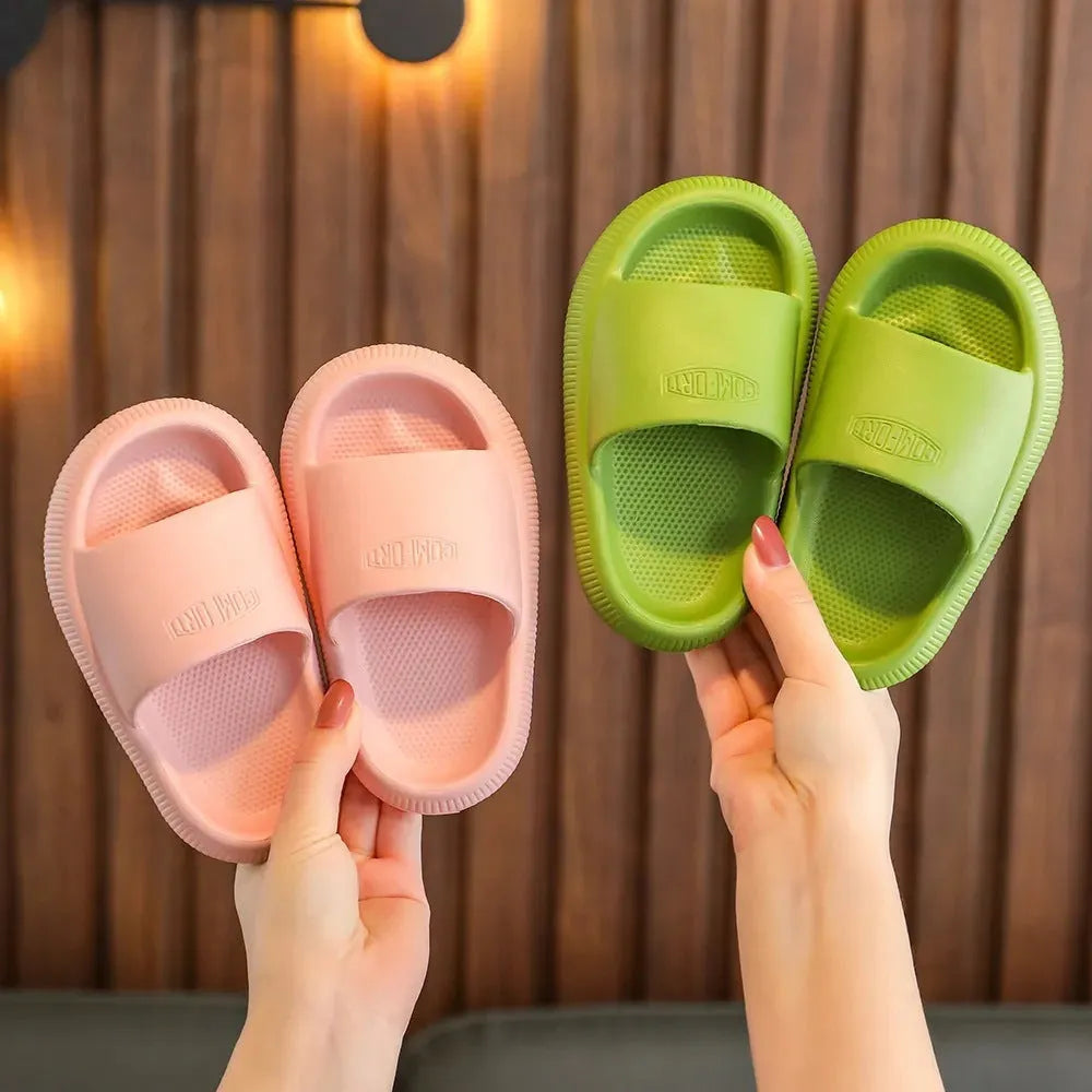 Colourful children's EVA slippers with a textured non-slip sole, shown in blue, green, orange, pink and yellow.