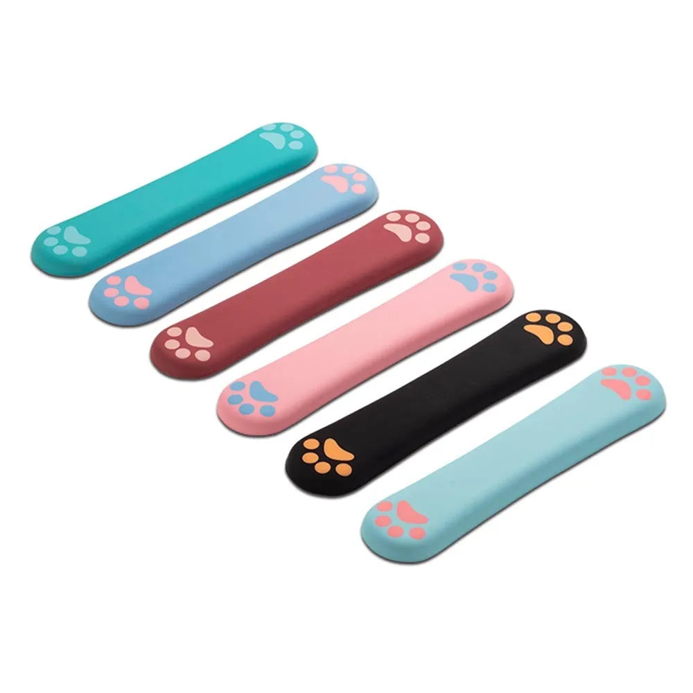 Cat's Claw cartoon design memory foam keyboard wrist rest pad in blue, shown on a desk.