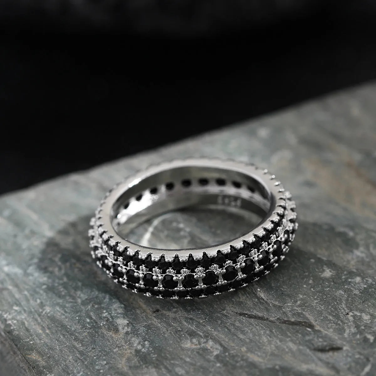 Personalised geometric triangle engagement ring with zircon inlay on a copper band.