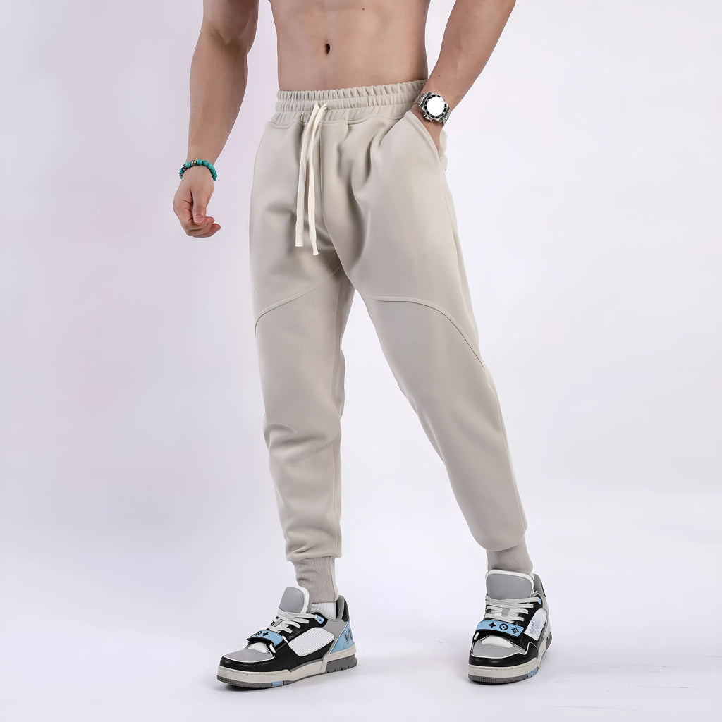 Men's ankle-tied drawstring sweatpants in polyester cotton, available in five colours and sizes M to XXXL
