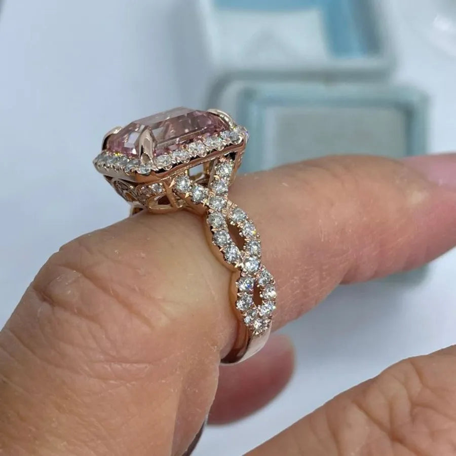 Rose gold geometric alloy ring on a plain background, showing its shape and electroplated finish.