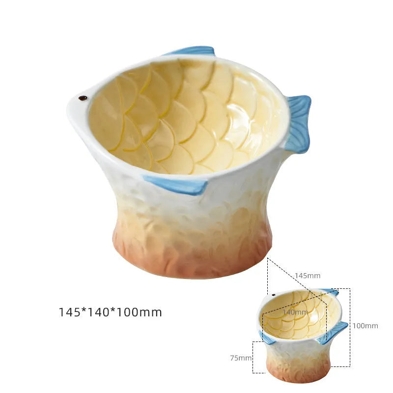 Set of four blue fish-shaped ceramic cat bowls with tilted, elevated design on a table.
