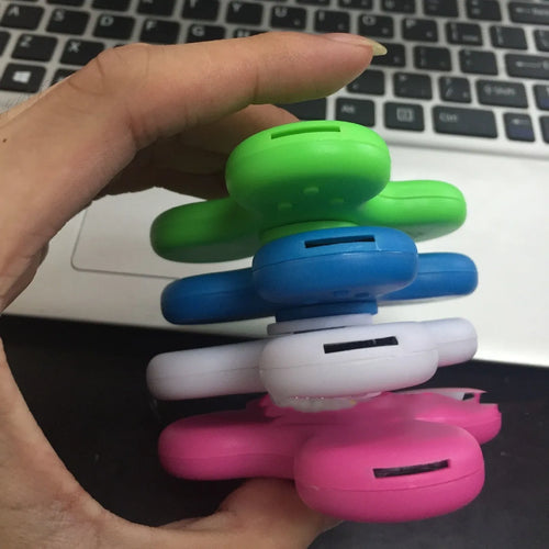 Compact white Bluetooth speaker and MP3 player designed as a fidget spinner toy.