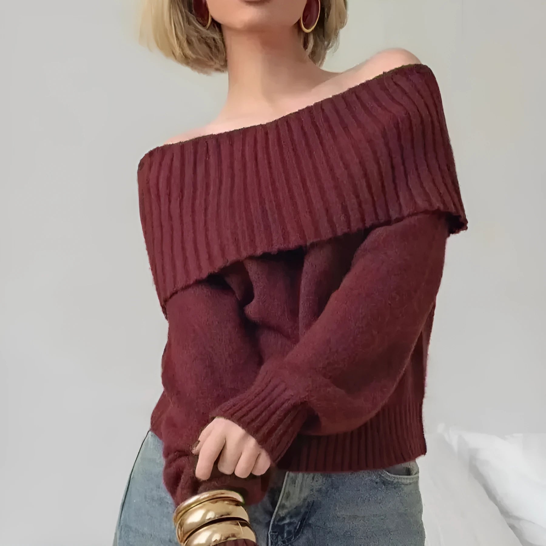 Grey off-the-shoulder strapless women's sweater with a 3D textured pattern.