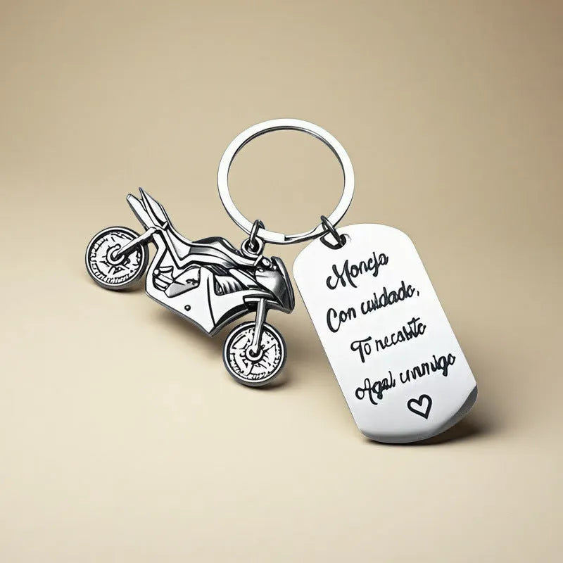 Stainless steel motorcycle-themed keychain on a velvet flannel bag