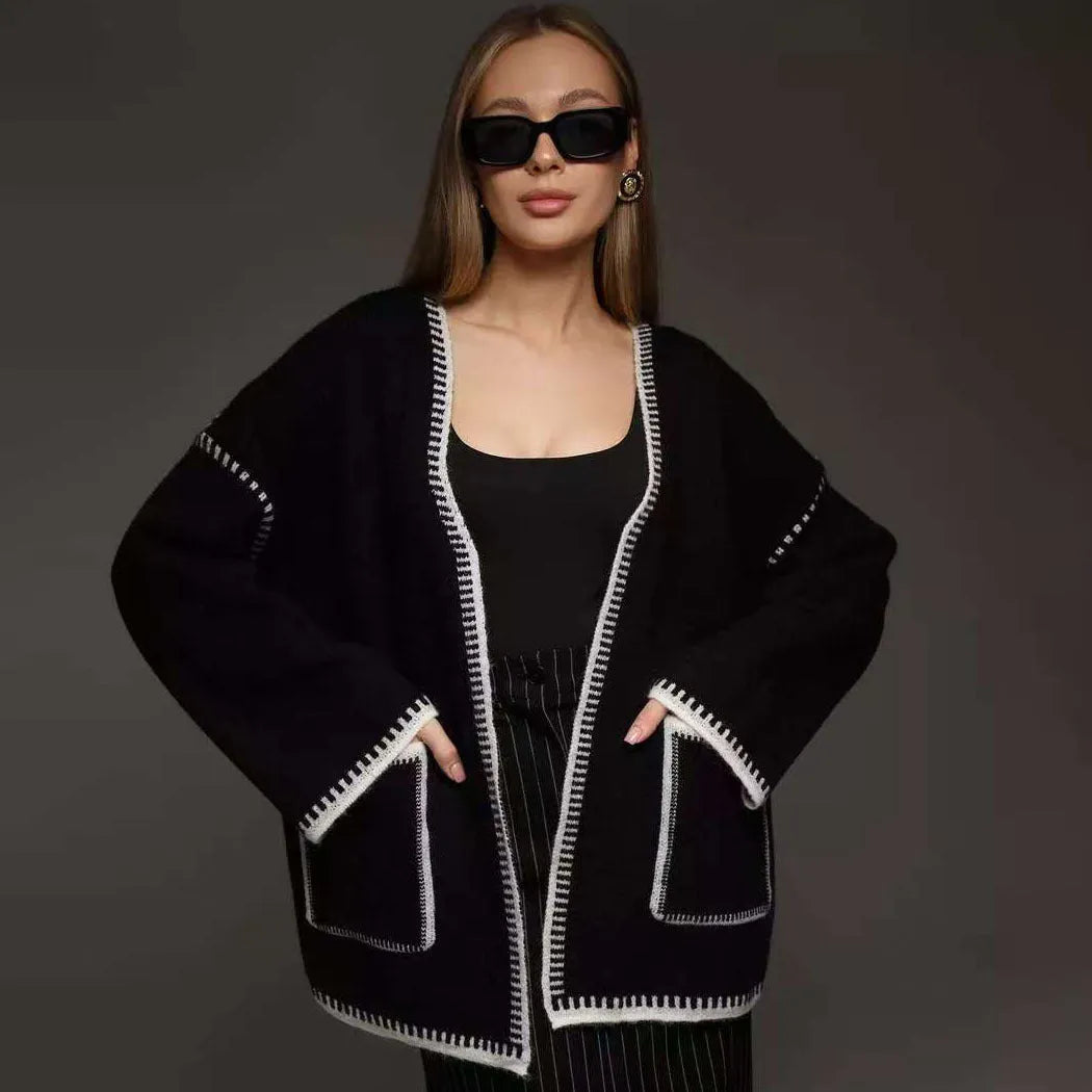 Loose black lace-up knitted cardigan sweater coat with long sleeves.
