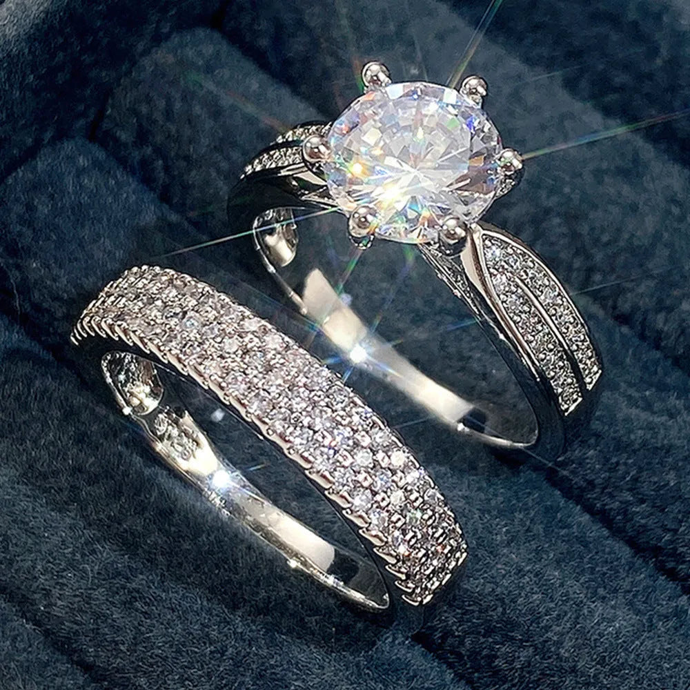 Geometric white gold colour alloy wedding ring bracelet with round detail on a finger.