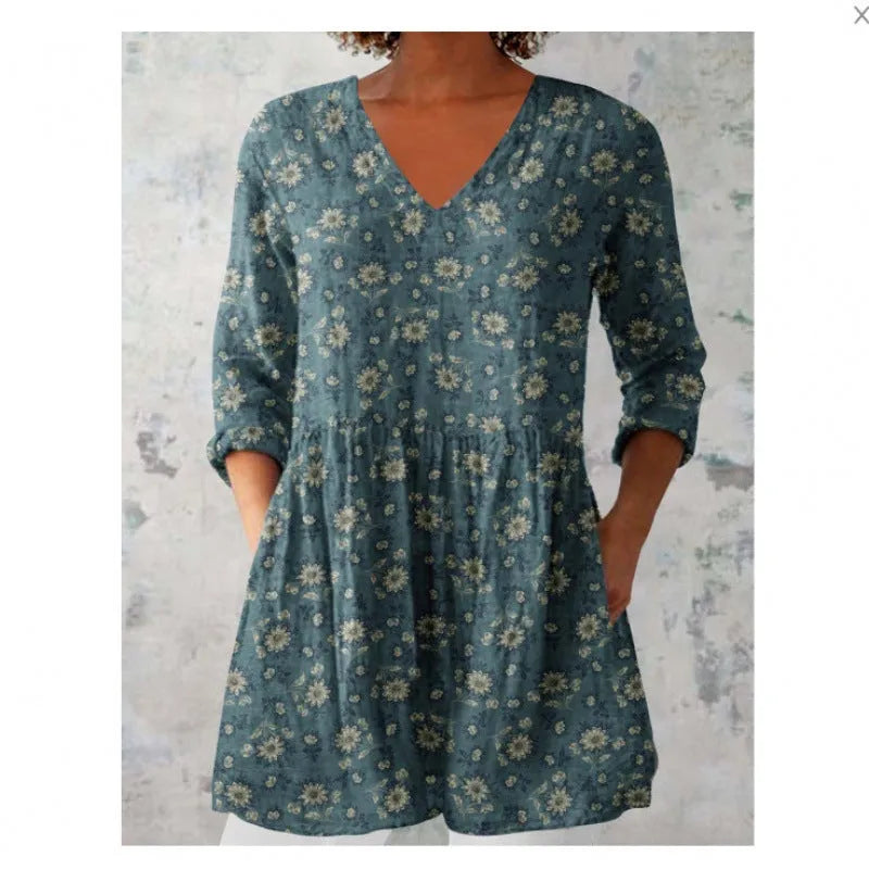 Women's floral wave print dress with wide waist and three-quarter length sleeves on a hanger.