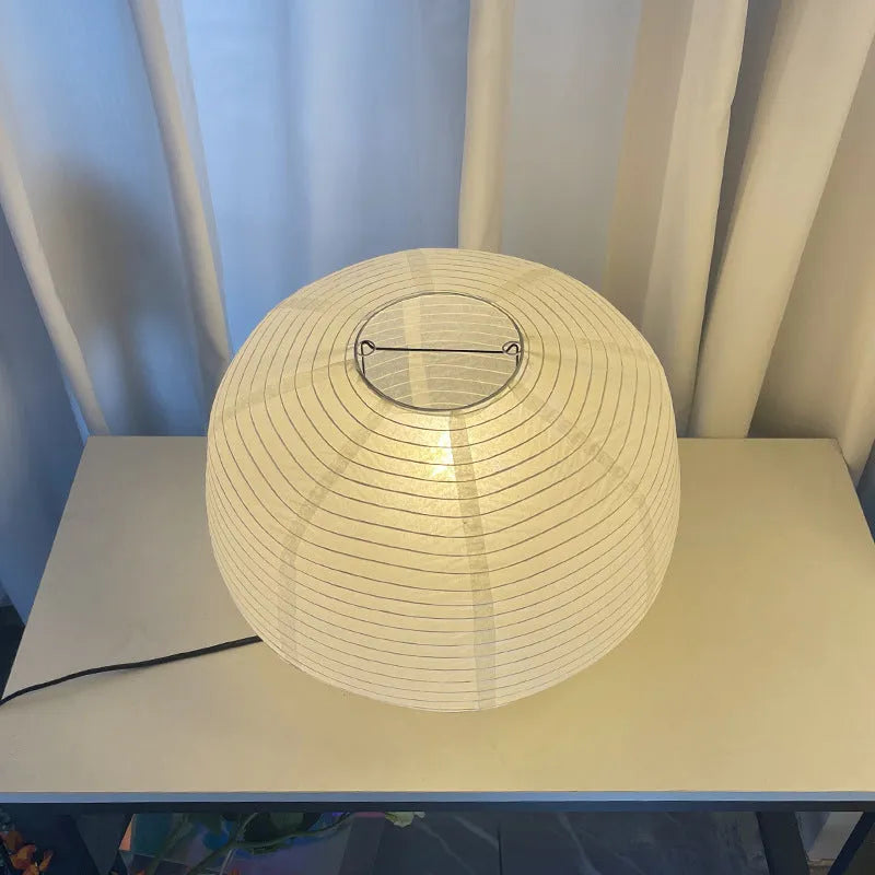 Japanese style xuan paper desk lamp on a wooden desk with soft warm light