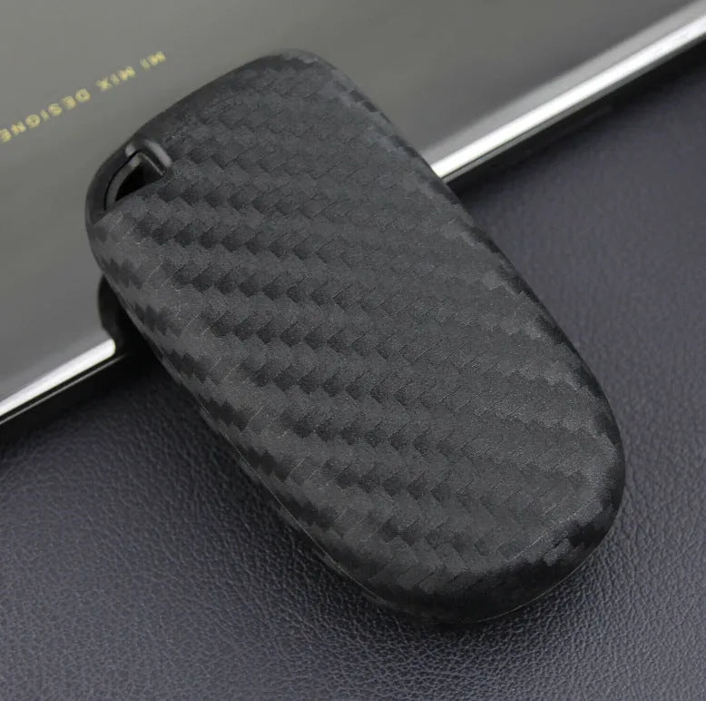 Black carbon fibre silicone key case for Dodge Chrysler Fiat car remote keys, shown in bag and buckle styles.