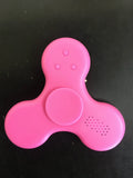 Compact white Bluetooth speaker and MP3 player designed as a fidget spinner toy.