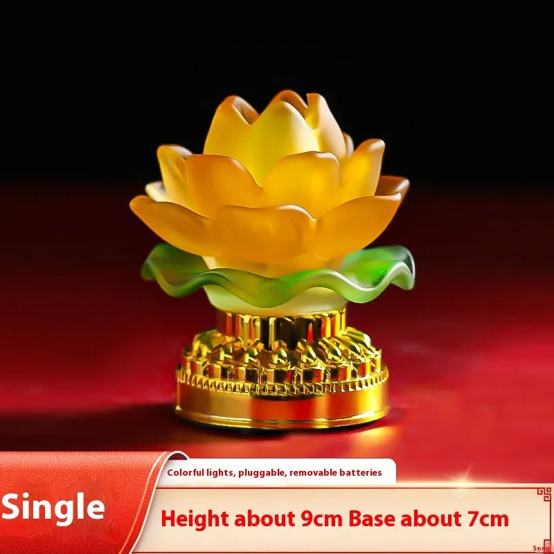 Yellow Chinese style Buddha lotus lamp on a wooden surface, shown in both flower bud and flowering designs.