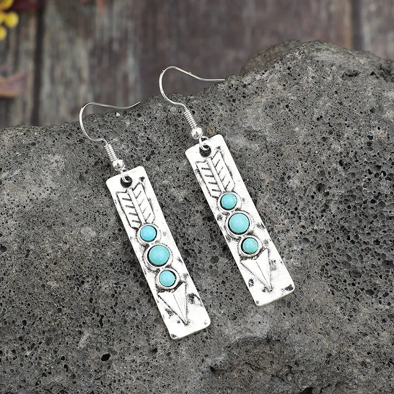 Silver geometric earrings with turquoise inlay in long strip design
