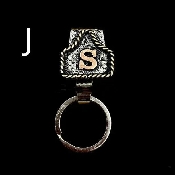Handmade metal cow tag style key holder shown in one of its 26 colour options, attached to a keyring.