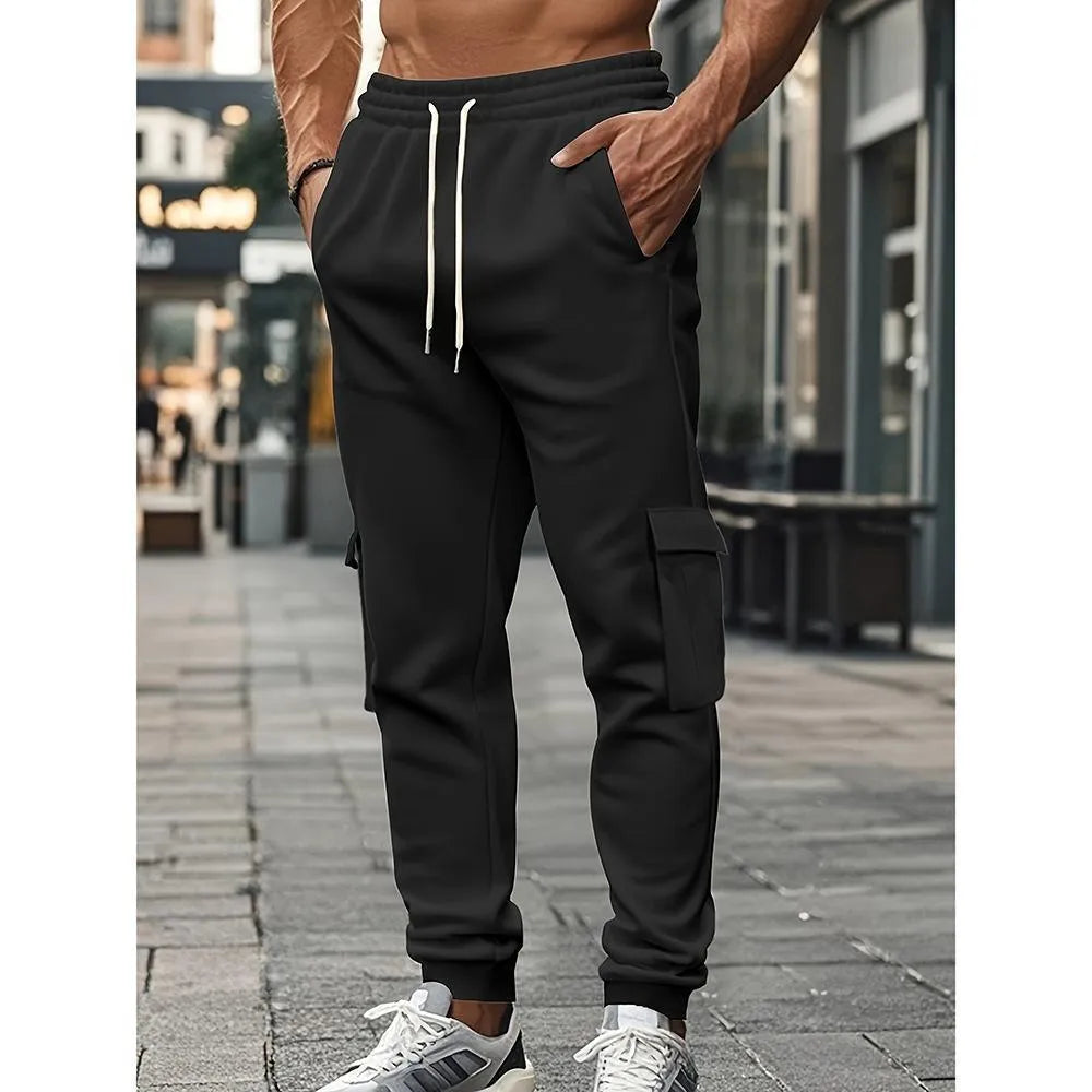 Men's solid colour casual multi-pocket drawstring sports pants in black, featuring polyester fabric and mid-waist design