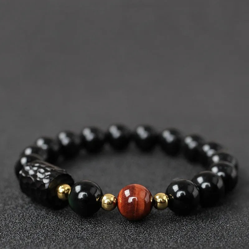Obsidian bracelet with 10mm yellow tiger eye beads showing manual processing details and retro circle style