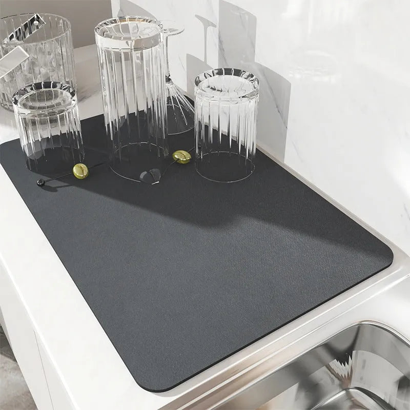 Black super absorbent square rubber drain pad mat on a kitchen countertop