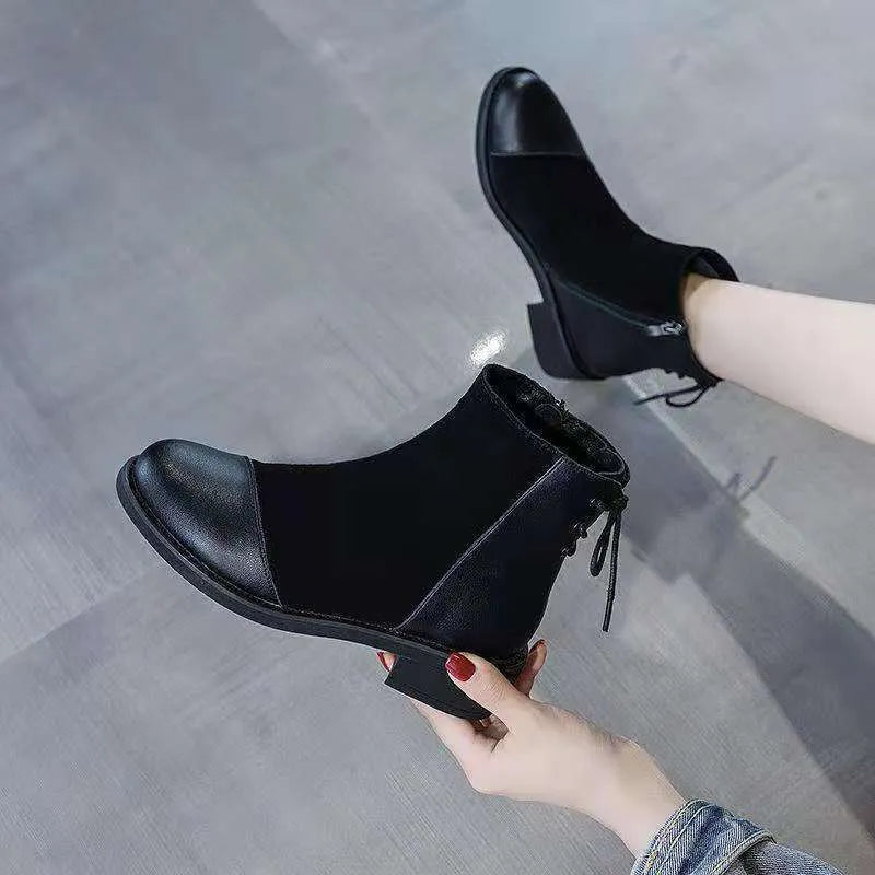 Black women's knee-high Martin boots with side zipper, round toe, and decorative bow.