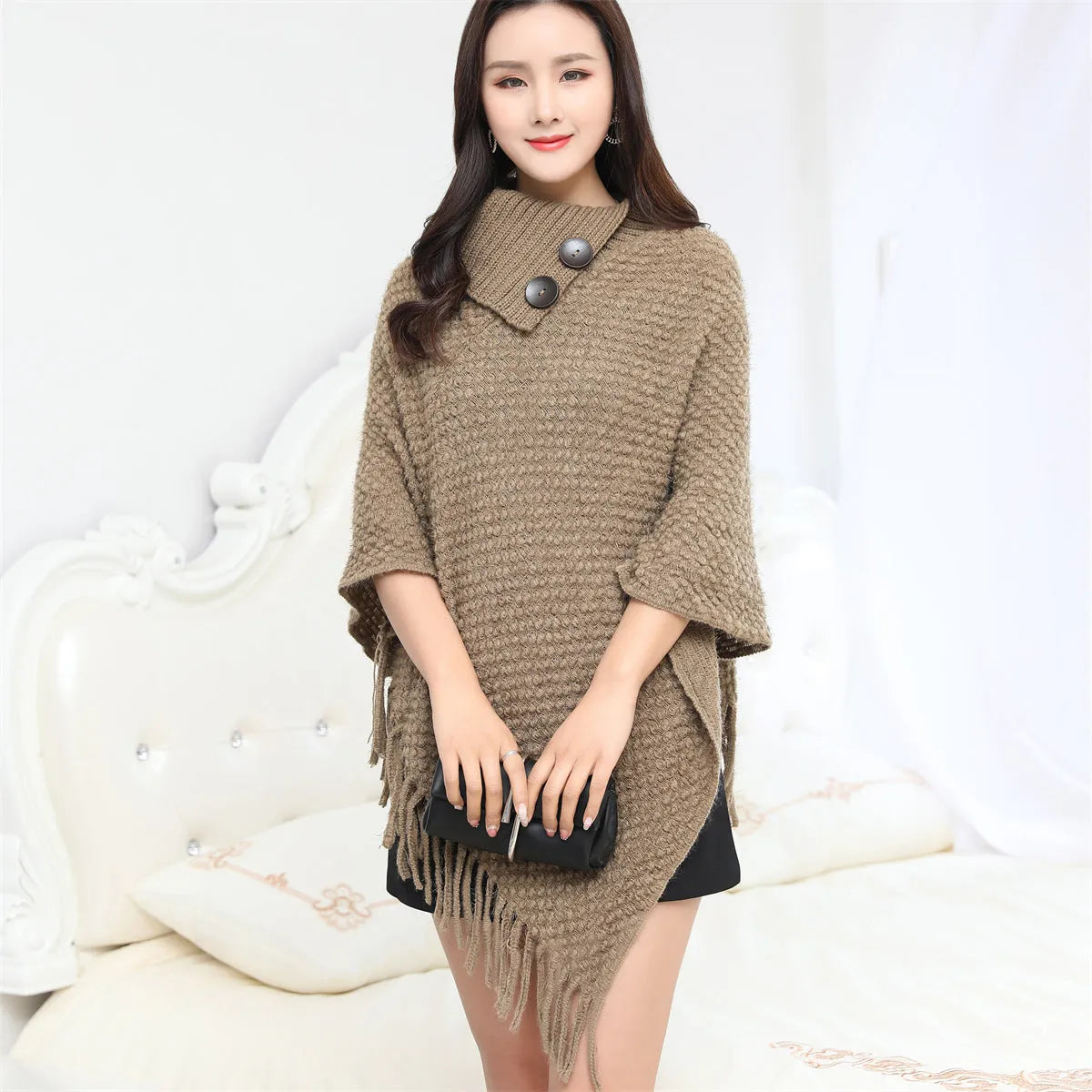 Women's knitted polka dot shawl cloak in sleeveless cape design showing colour options