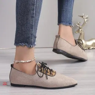 Beige leopard print women's pointed toe pumps on a white background.