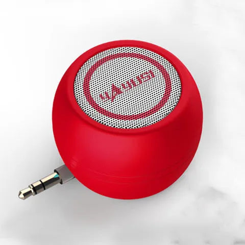 A5 portable mini speaker in red with 3.5mm audio plug and ABS plastic casing on a table