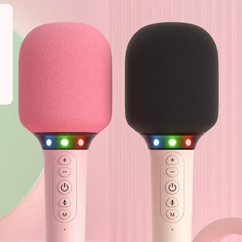 Pink Bluetooth children's handheld karaoke microphone with built-in speaker on white background