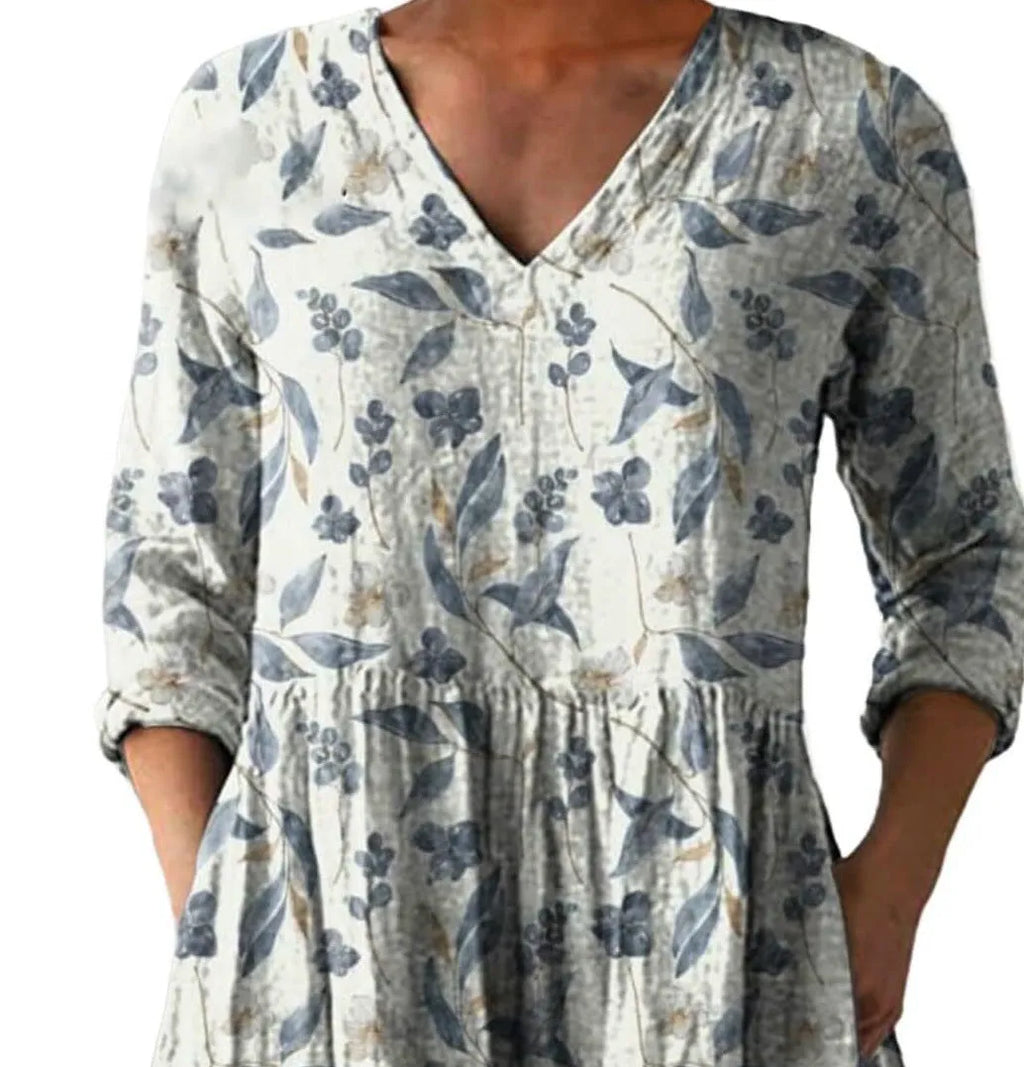 Women's floral wave print dress with wide waist and three-quarter length sleeves on a hanger.