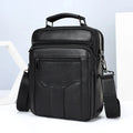 Men's genuine leather messenger bag in black with visible sewing line details and shoulder strap