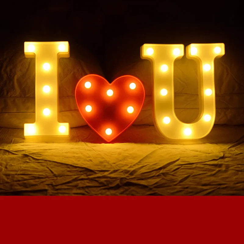 Plastic LED letter light decoration spelling a message, 22cm in height.
