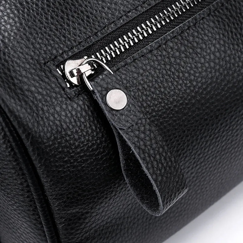 Black genuine leather crossbody bag showing adjustable strap and main compartment