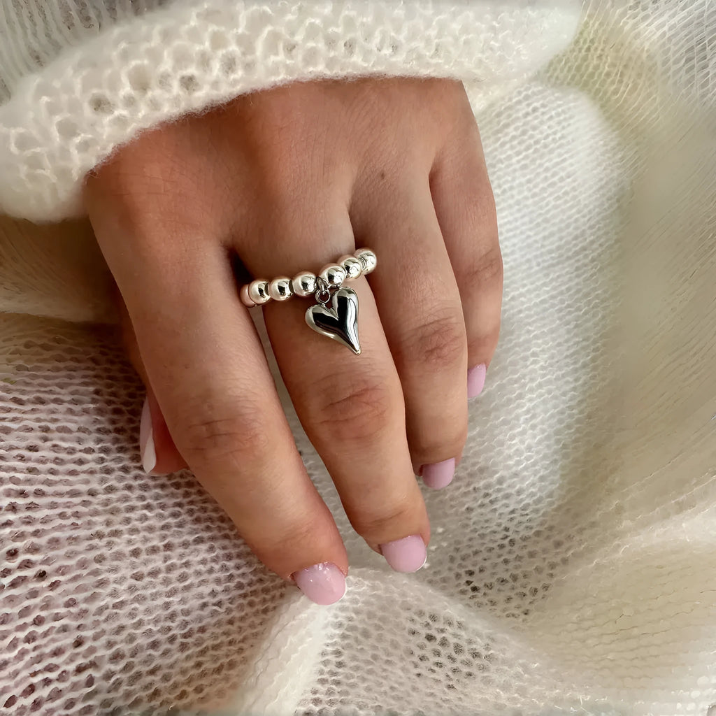 Handmade beaded elastic string love ring with geometric heart design in gold and white colour options