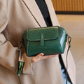 Brown oil wax leather women's messenger bag with cross-body strap showing shell shape and interior compartments