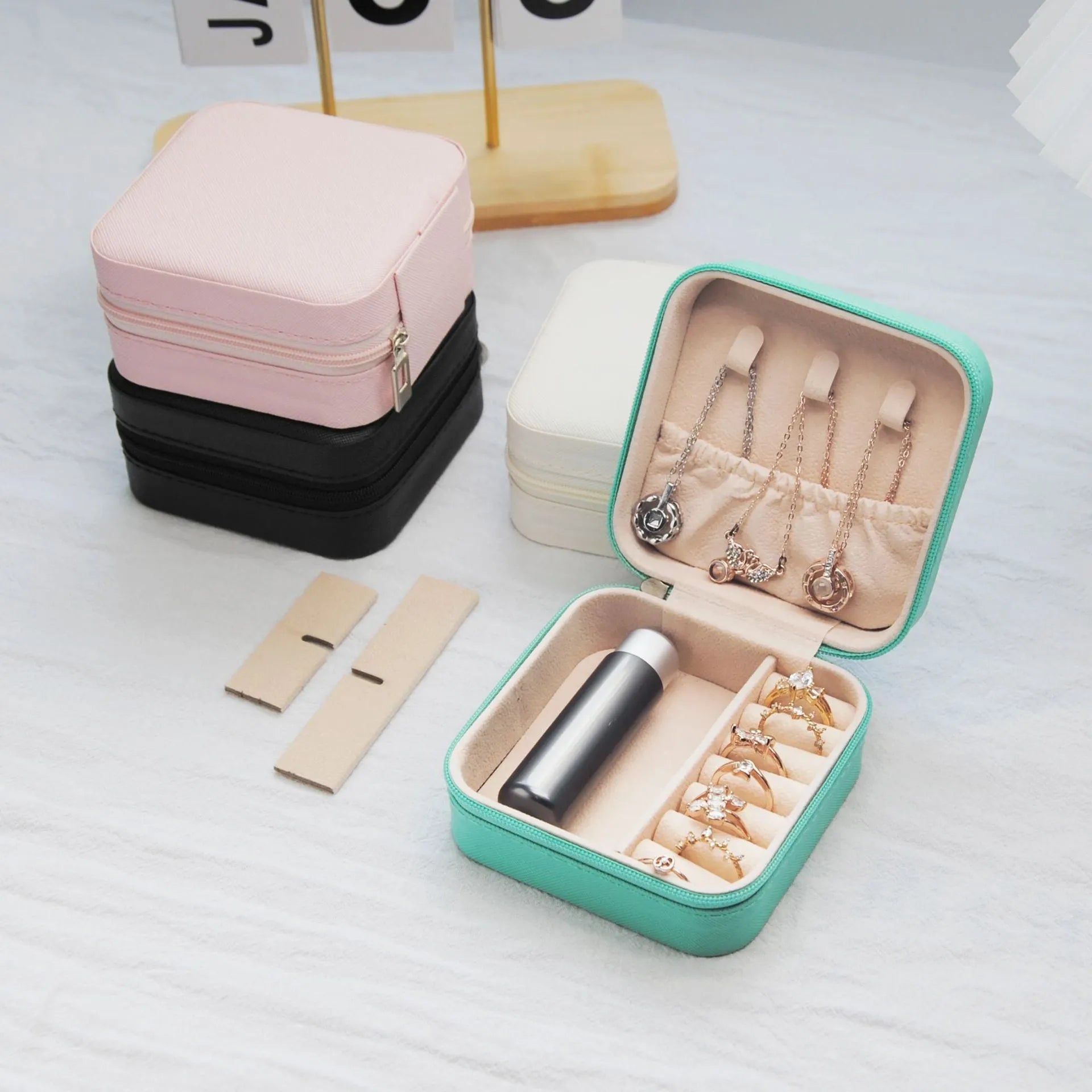 Small leather jewellery box in cross pattern, 10cm size, for earrings and rings, on a flat surface.