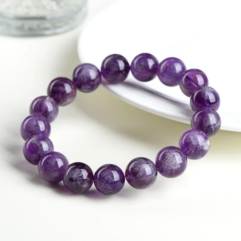 Snow Mountain feather amethyst crystal bracelet with scattered geometric beads and Ruyi element.