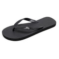 Men's black flip-flops with a textured rubber sole and EVA foam upper on a sandy beach.