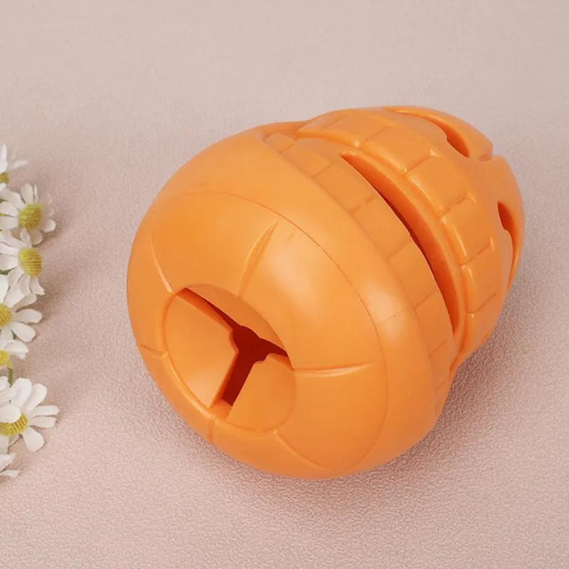 Yellow pumpkin-shaped TPR dog chew toy for aggressive chewers on white background