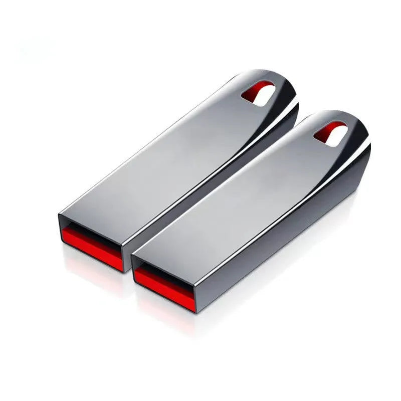 Silver metal USB flash drive on a white background showing its USB connector.