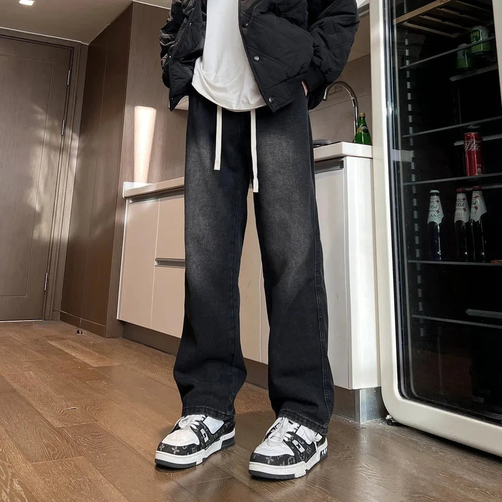 Men's loose fit straight-leg jeans in black or blue with drawstring waist closure