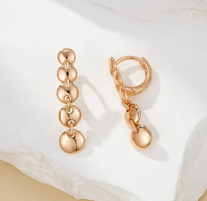 Long round gold retro earrings with woven copper texture, shown as a pair.