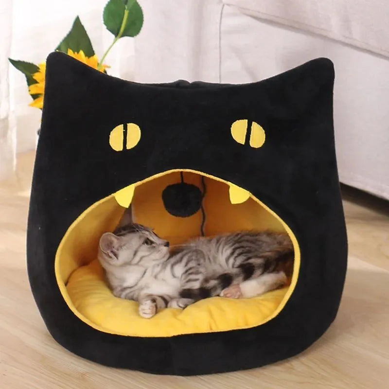 Grey cat-shaped covered pet bed with a removable cushion, shown on a wooden floor.