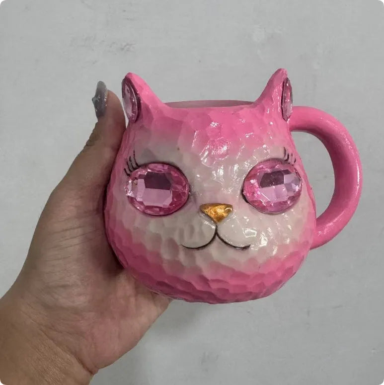 Resin cat cup crystal globe decorative ornament on a desk, shown in purple colour.