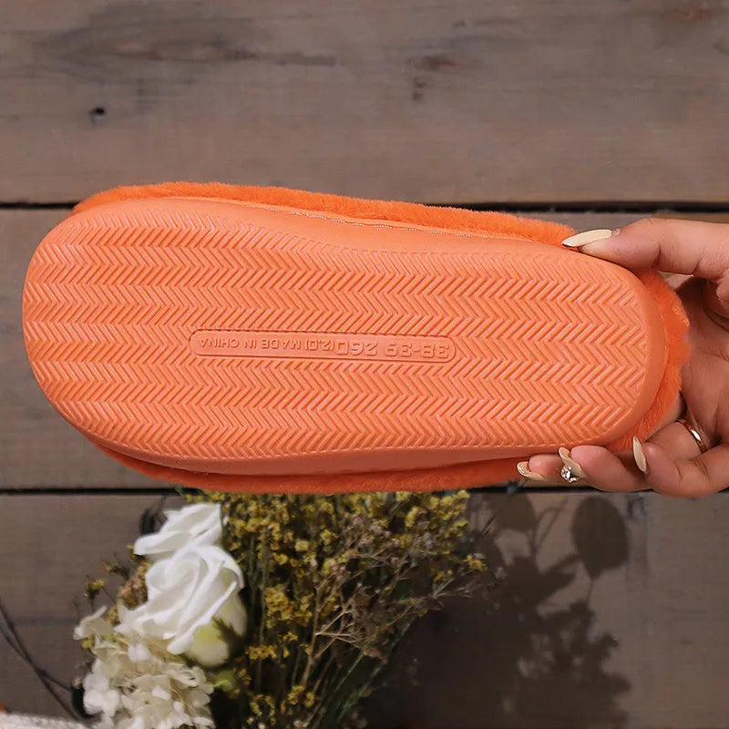 Orange pumpkin-shaped coral velvet plush slippers with a flat PVC sole.