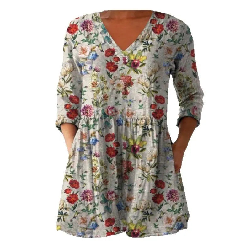 Women's floral wave print dress with wide waist and three-quarter length sleeves on a hanger.