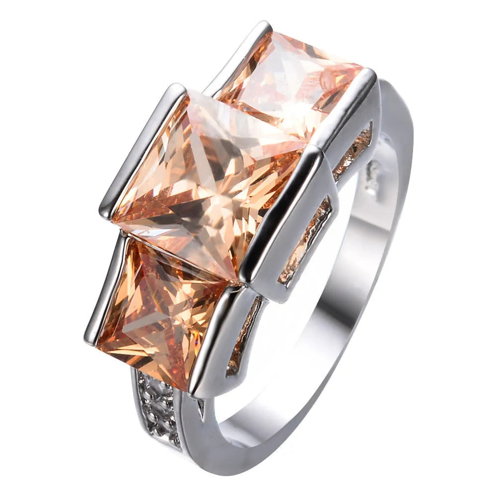Geometric wholesale ring ornament in electroplated copper showing multiple colour options on a size 8 finger