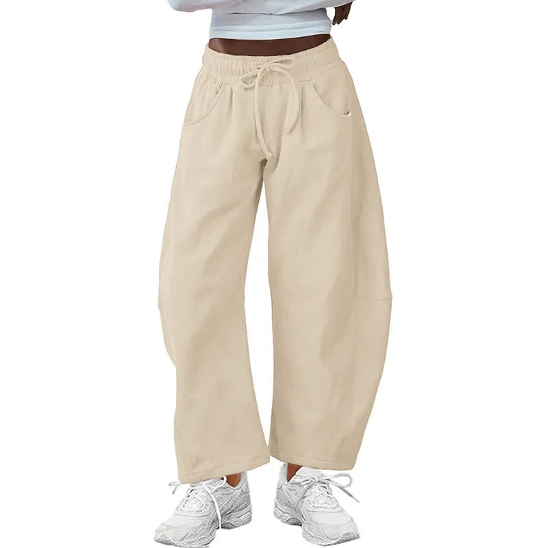 Loose cropped sweatpants with drawstring waist and side pockets in street fashion styling