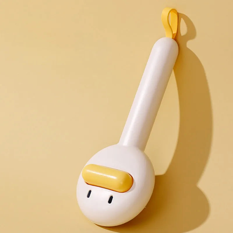Small yellow duck-shaped pet grooming comb with open-section needle brush design for cat and dog hair removal