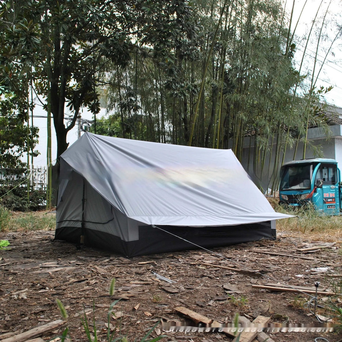 Brown A-line tent for 2-3 people with PU4000 waterproof fabric, 210x150x110cm, set in a grassy campsite.